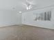 Open living room featuring carpet, a ceiling fan, and a bright window at 13875 Se 97Th Ave, Summerfield, FL 34491
