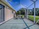 Covered screened patio featuring a stone table and bench seating, great for outdoor entertaining at 13875 Se 97Th Ave, Summerfield, FL 34491