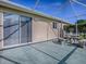 Covered patio with outdoor seating area and sliding glass door at 13875 Se 97Th Ave, Summerfield, FL 34491