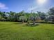 Expansive lawn with well-placed palm trees that contribute to the lush and inviting landscape at 13875 Se 97Th Ave, Summerfield, FL 34491