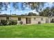 A lush backyard featuring well-maintained lawn and a sliding glass door at 1416 Abigail Dr, Apopka, FL 32703
