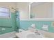A charming bathroom featuring retro blue tile and accessibility features at 1416 Abigail Dr, Apopka, FL 32703