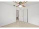 A simple bedroom featuring neutral carpet and a ceiling fan at 1416 Abigail Dr, Apopka, FL 32703