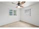 A bedroom bathed in sunlight, featuring neutral carpet and a ceiling fan at 1416 Abigail Dr, Apopka, FL 32703