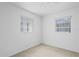 A bedroom bathed in sunlight, featuring neutral carpet and multiple windows at 1416 Abigail Dr, Apopka, FL 32703