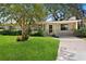 Charming single-story home featuring a lush green lawn, mature tree, and inviting front entrance at 1416 Abigail Dr, Apopka, FL 32703