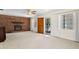 Cozy living room featuring a brick fireplace, neutral carpet and natural light at 1416 Abigail Dr, Apopka, FL 32703