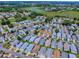Picturesque aerial view of a residential neighborhood near a golf course and lush greenery at 1722 Moreno Pl, The Villages, FL 32159