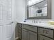 Bright bathroom featuring a vanity with ample storage, a mirror, and a shower with glass doors at 1722 Moreno Pl, The Villages, FL 32159