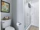 Cozy bathroom featuring a toilet, stylish wall art, and a shower with glass doors at 1722 Moreno Pl, The Villages, FL 32159