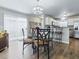 Cozy dining area with a glass table, stylish chandelier, and convenient access to the kitchen and backyard at 1722 Moreno Pl, The Villages, FL 32159