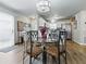 Inviting dining area featuring a glass table, modern chandelier, and bright, neutral décor at 1722 Moreno Pl, The Villages, FL 32159