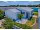 Aerial shot of a well-maintained home featuring a garage, mature trees, and manicured landscaping at 1722 Moreno Pl, The Villages, FL 32159