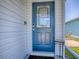 Beautiful blue front door with decorative glass and a digital lock for added security at 1722 Moreno Pl, The Villages, FL 32159