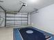 A spacious garage interior featuring a large carpet, white walls, and an automatic garage door opener at 1722 Moreno Pl, The Villages, FL 32159