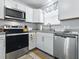 Well-equipped kitchen with stainless steel appliances, ample counter space, and a window above the sink at 1722 Moreno Pl, The Villages, FL 32159