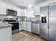 Modern kitchen with stainless steel appliances, granite countertops, and ample cabinet space at 1722 Moreno Pl, The Villages, FL 32159