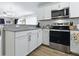 Bright kitchen featuring granite countertops and stainless steel appliances at 1722 Moreno Pl, The Villages, FL 32159