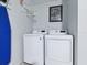 Bright laundry room with modern LG washer and dryer and humorous 'Big Bang Theory' poster at 1722 Moreno Pl, The Villages, FL 32159