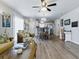 Bright living space with wood-look floors, ceiling fan, and an open floor plan at 1722 Moreno Pl, The Villages, FL 32159