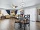Open-concept living and dining area with abundant natural light and wood-look flooring at 1722 Moreno Pl, The Villages, FL 32159