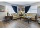 Cozy living room features comfortable couches, stylish lamps, and lots of natural light at 1722 Moreno Pl, The Villages, FL 32159