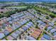 Aerial view of the neighborhood showcasing its location, landscaping, and proximity to a lake and golf course at 1722 Moreno Pl, The Villages, FL 32159
