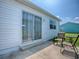 Relaxing patio with seating area just outside a sliding glass door at 1722 Moreno Pl, The Villages, FL 32159