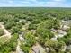 Scenic aerial view of the neighborhood surrounded by verdant trees and residential homes under a sunny sky at 1725 14Th St, Orange City, FL 32763