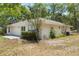 Rear exterior view of home with tidy landscaping, showcasing its charming architecture at 1725 14Th St, Orange City, FL 32763