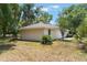 Landscaped backyard featuring the home's exterior with a focus on natural surroundings at 1725 14Th St, Orange City, FL 32763