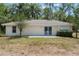 Home's backyard showcasing the exterior, including a patio and well-maintained lawn at 1725 14Th St, Orange City, FL 32763