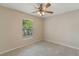 Relaxing bedroom with a ceiling fan and large window offering a serene outdoor view at 1725 14Th St, Orange City, FL 32763