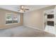 Bedroom with natural light from window and ceiling fan, leading into an adjacent room at 1725 14Th St, Orange City, FL 32763