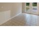 Bonus room showcasing tiled floor, wainscotting, and a glass paned exterior door at 1725 14Th St, Orange City, FL 32763