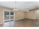 Dining area featuring wood floors, a chandelier, ceiling fan, and sliding glass doors to the backyard at 1725 14Th St, Orange City, FL 32763
