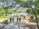 Charming single-story home with double doors, light-colored exterior, and mature landscaping at 1725 14Th St, Orange City, FL 32763