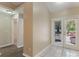 Hallway showcasing wood floors, light walls, and views of the exterior through glass paned double doors at 1725 14Th St, Orange City, FL 32763