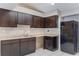 Kitchen featuring dark cabinetry, light countertops, white tile flooring, and black appliances at 1725 14Th St, Orange City, FL 32763