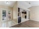 View of the kitchen from living room with white tiled floors, double doors, and an open floor plan at 1725 14Th St, Orange City, FL 32763