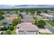 Residential home with lush landscaping near golf course and water feature in a well-planned neighborhood at 1813 Caryle Ln, The Villages, FL 32162
