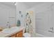 Bathroom featuring a shower and bathtub combination, a single sink vanity, and fun decor at 1813 Caryle Ln, The Villages, FL 32162