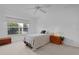 Bright bedroom features neutral decor, a ceiling fan, and natural light from the window at 1813 Caryle Ln, The Villages, FL 32162