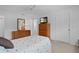 Comfortable bedroom featuring a ceiling fan, neutral decor, and ample closet space at 1813 Caryle Ln, The Villages, FL 32162
