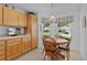 Bright breakfast nook with wooden table, chairs, and natural light from the windows at 1813 Caryle Ln, The Villages, FL 32162