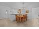Dining room boasts tile flooring and an elegant light fixture above the dining table at 1813 Caryle Ln, The Villages, FL 32162