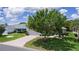 Beautiful single-story home with a two-car garage, well-maintained lawn, and mature trees at 1813 Caryle Ln, The Villages, FL 32162