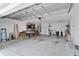 Large garage featuring a utilitarian sink, ample storage and bright lighting at 1813 Caryle Ln, The Villages, FL 32162