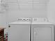 Laundry area featuring a white washer and dryer for easy laundry days at 1813 Caryle Ln, The Villages, FL 32162