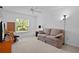 Cozy living room with neutral carpet and paint, lots of natural light and a comfortable couch at 1813 Caryle Ln, The Villages, FL 32162